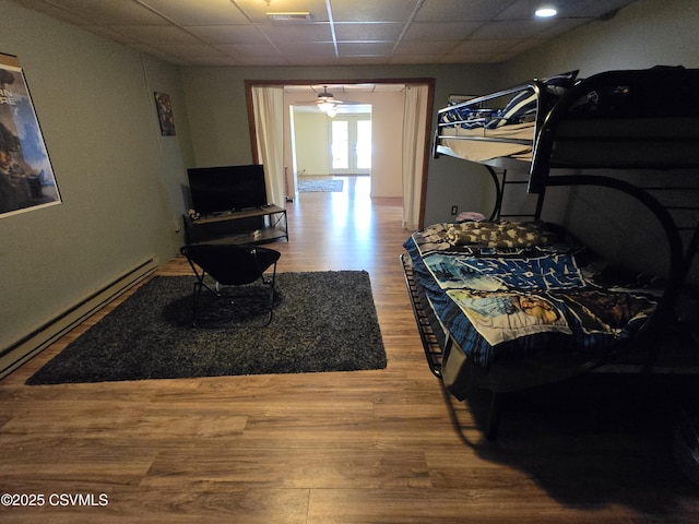 444 Frederick Dr, Watsontown, PA 17777 - bedroom with a paneled ceiling, a baseboard heating unit, visible vents, and wood finished floors