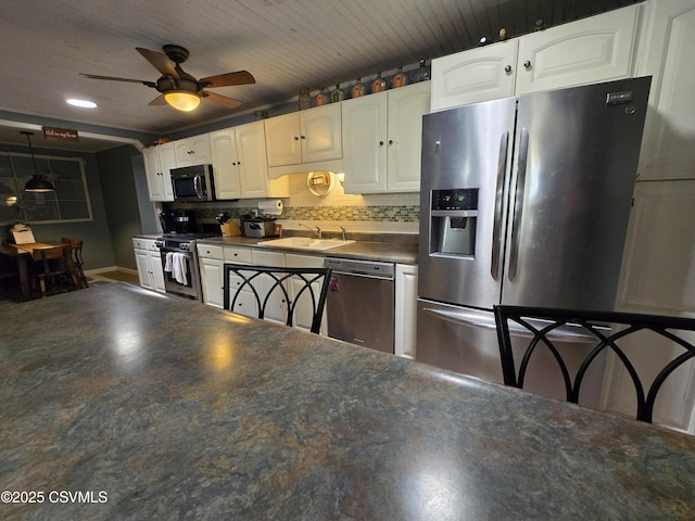 444 Frederick Dr, Watsontown, PA 17777 - kitchen featuring dark countertops, ceiling fan, a sink, stainless steel appliances, and white cabinetry