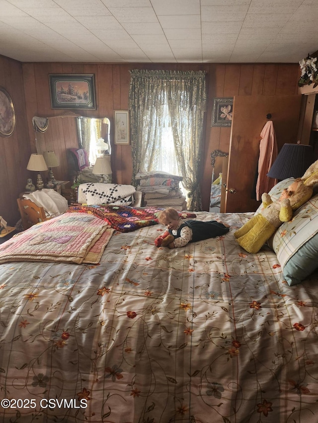 bedroom with wooden walls