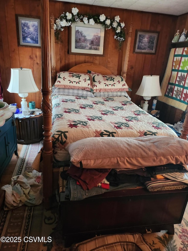 bedroom with wood walls