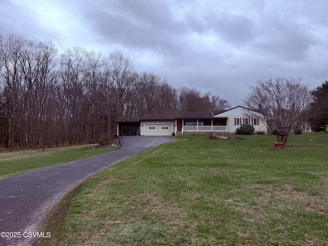 73 Seneca Dr, Shickshinny, PA 18655 - view of front of house with a garage, driveway, a front yard, and covered porch