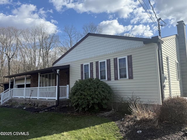 73 Seneca Dr, Shickshinny, PA 18655 - view of front of house featuring a chimney, a porch, and a front yard