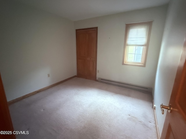 73 Seneca Dr, Shickshinny, PA 18655 - unfurnished bedroom with baseboard heating, baseboards, a closet, and carpet