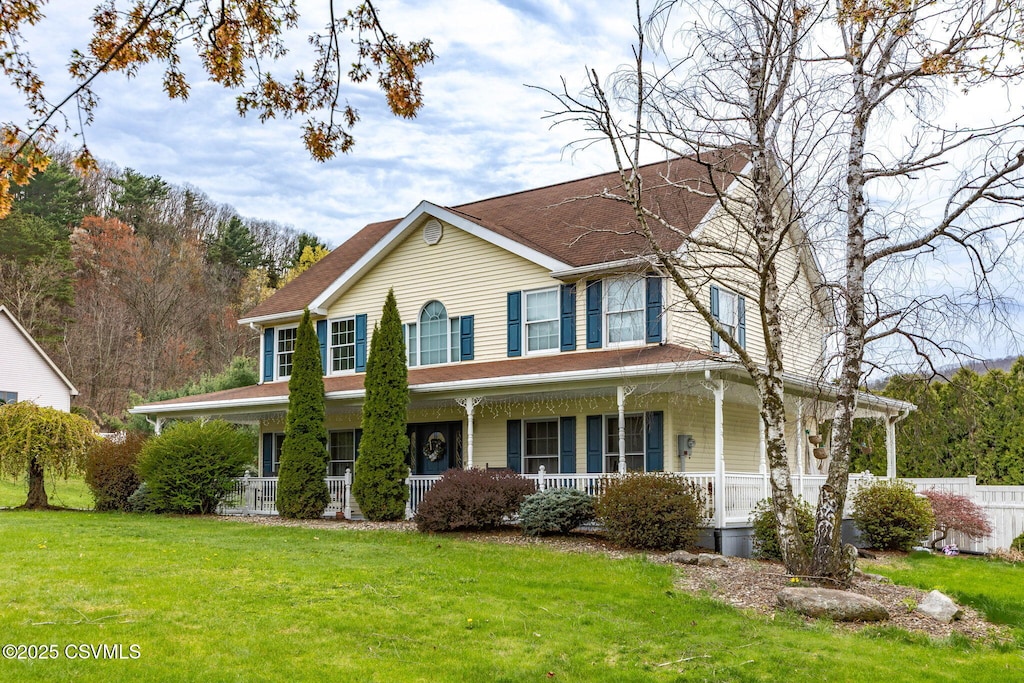 farmhouse-style home with a porch and a front yard