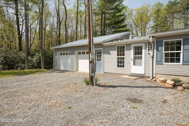 garage with gravel driveway