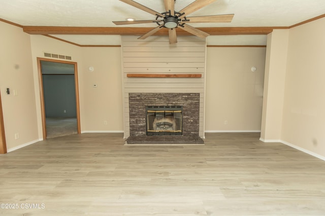 unfurnished living room featuring visible vents, ornamental molding, and wood finished floors