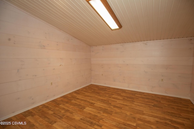bonus room with wooden walls, wood ceiling, wood finished floors, and lofted ceiling
