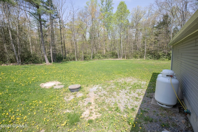view of yard with a view of trees