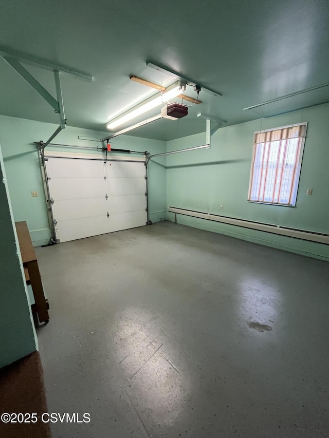 garage featuring baseboard heating and a garage door opener