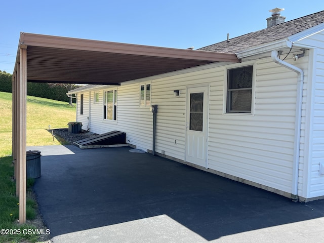 view of patio / terrace with a carport and cooling unit