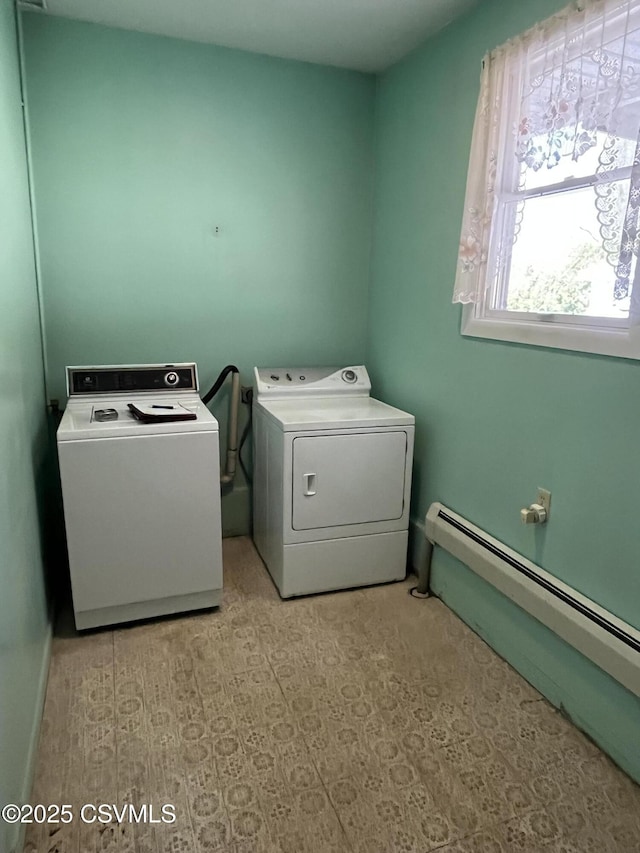 laundry area featuring independent washer and dryer, baseboard heating, and laundry area
