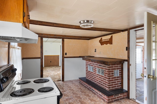 1205 N River Ave, Sunbury, PA 17801 - kitchen with white electric range oven, under cabinet range hood, wood walls, a wainscoted wall, and beamed ceiling