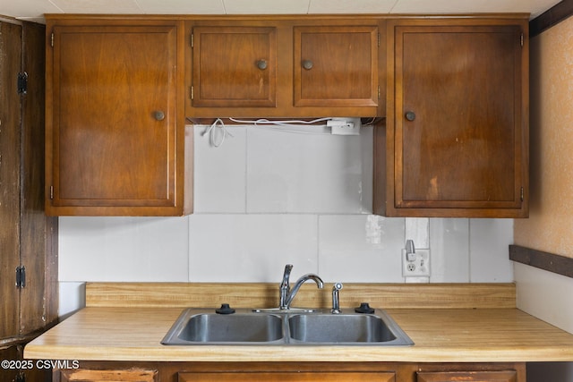 1205 N River Ave, Sunbury, PA 17801 - kitchen with a sink, tasteful backsplash, and brown cabinets