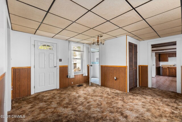 1205 N River Ave, Sunbury, PA 17801 - carpeted entrance foyer featuring wainscoting, wood walls, a drop ceiling, and a sink
