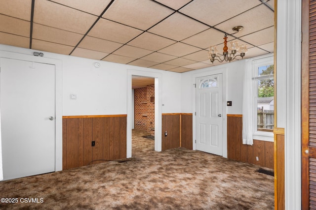 1205 N River Ave, Sunbury, PA 17801 - entrance foyer featuring wainscoting, wood walls, carpet floors, and a paneled ceiling