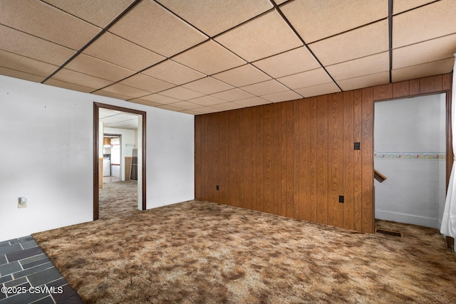 1205 N River Ave, Sunbury, PA 17801 - carpeted spare room featuring wooden walls and a drop ceiling