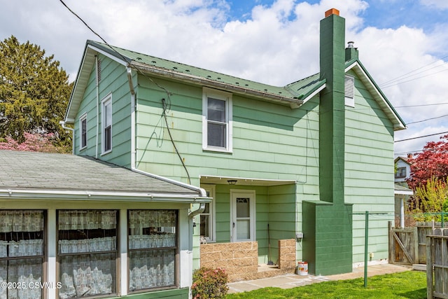 1205 N River Ave, Sunbury, PA 17801 - back of house with a chimney, fence, and metal roof