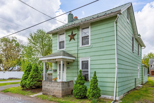 1205 N River Ave, Sunbury, PA 17801 - view of front facade featuring a chimney, fence, and metal roof