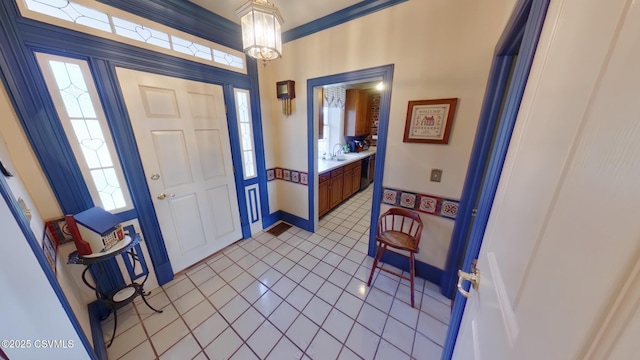 foyer featuring light tile patterned flooring and healthy amount of natural light