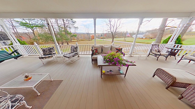 wooden terrace featuring an outdoor living space