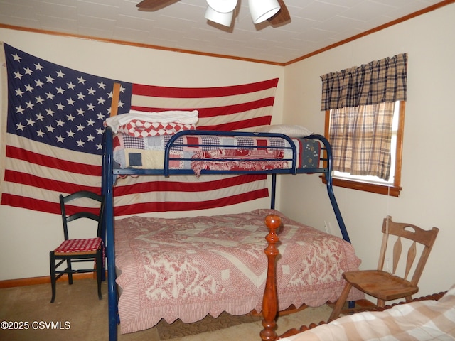 bedroom with carpet flooring, baseboards, ceiling fan, and crown molding