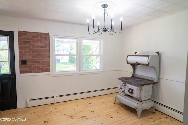 302 Walnut St, Selinsgrove, PA 17870 - dining room featuring baseboard heating, a notable chandelier, a wainscoted wall, and plenty of natural light