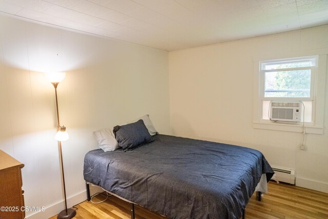 302 Walnut St, Selinsgrove, PA 17870 - bedroom featuring cooling unit, baseboards, wood finished floors, and a baseboard radiator