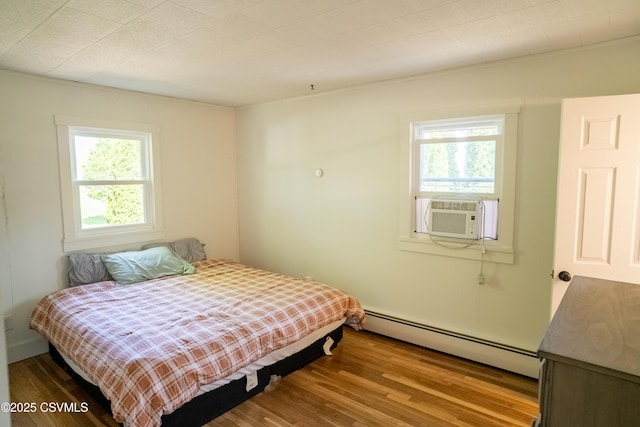 302 Walnut St, Selinsgrove, PA 17870 - bedroom featuring a baseboard heating unit, cooling unit, and wood finished floors