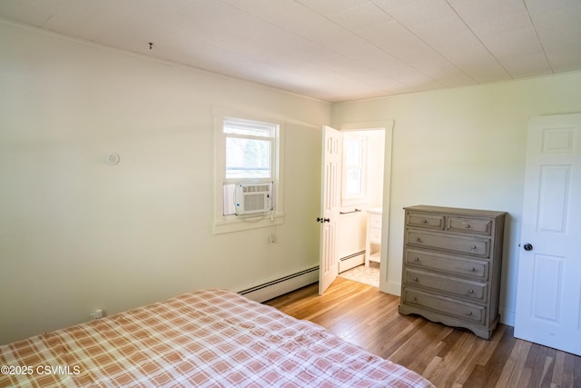 302 Walnut St, Selinsgrove, PA 17870 - bedroom featuring wood finished floors, cooling unit, ensuite bathroom, and a baseboard heating unit