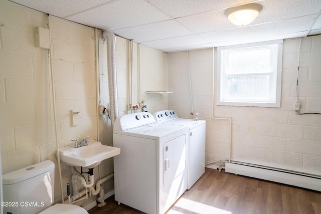 302 Walnut St, Selinsgrove, PA 17870 - washroom with wood finished floors, a sink, concrete block wall, and washing machine and dryer