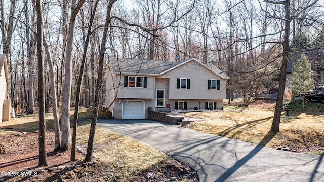 bi-level home featuring driveway and an attached garage