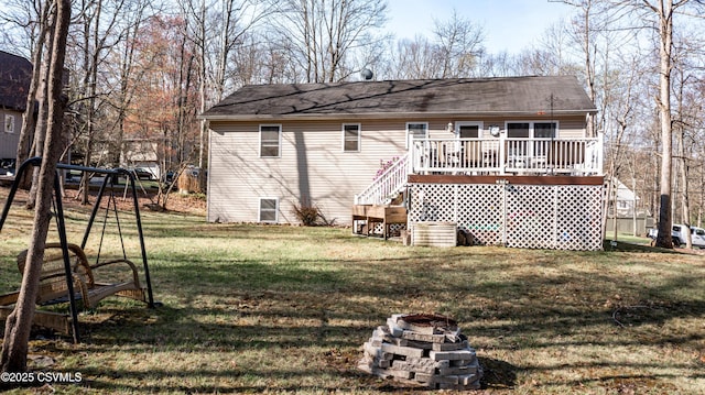 back of house featuring stairway, a shingled roof, a lawn, a deck, and a fire pit