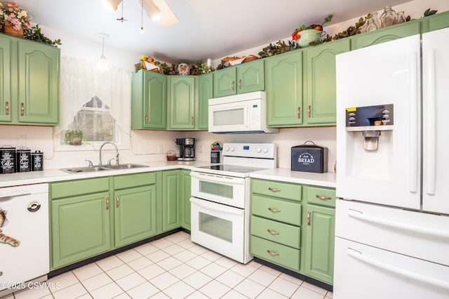 kitchen with light tile patterned floors, light countertops, a sink, and white appliances