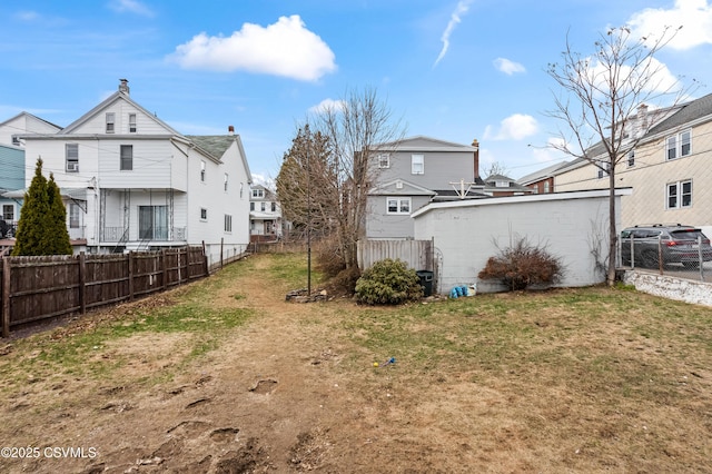 view of yard with a residential view and fence