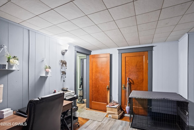office area featuring wood finished floors and a decorative wall