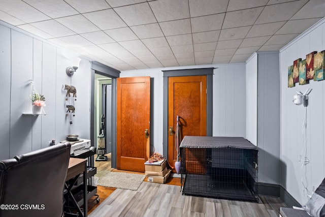 interior space featuring wood finished floors and a decorative wall