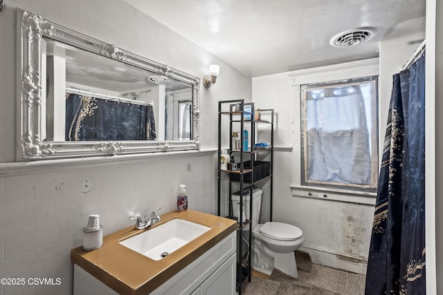 full bathroom with visible vents, toilet, and vanity