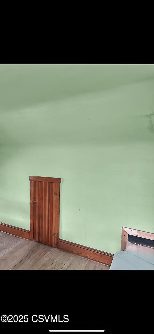 interior space featuring light wood-type flooring and baseboards