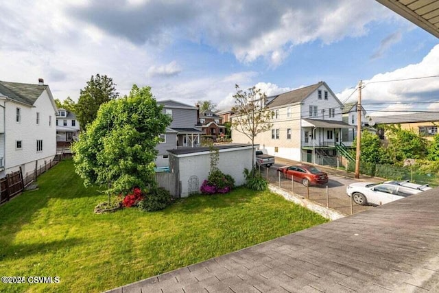 view of yard featuring fence and a residential view