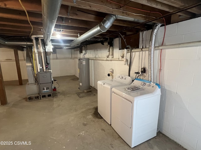 laundry area featuring water heater, heating unit, laundry area, and washing machine and dryer