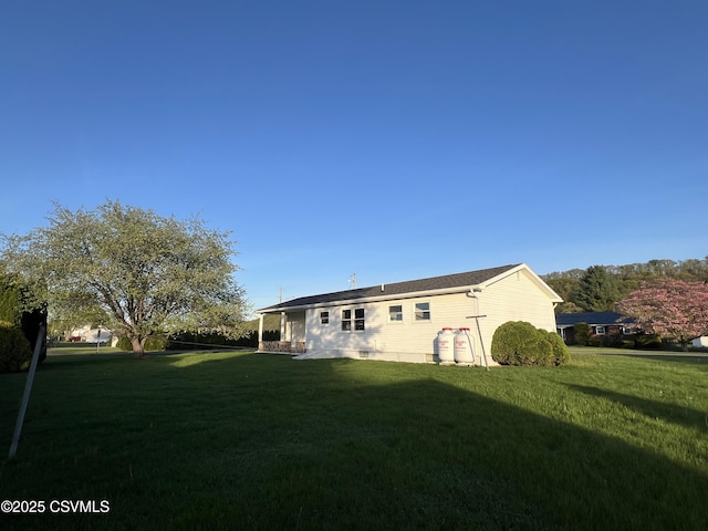 rear view of property featuring a yard