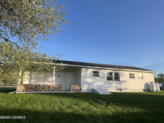 rear view of property with a yard