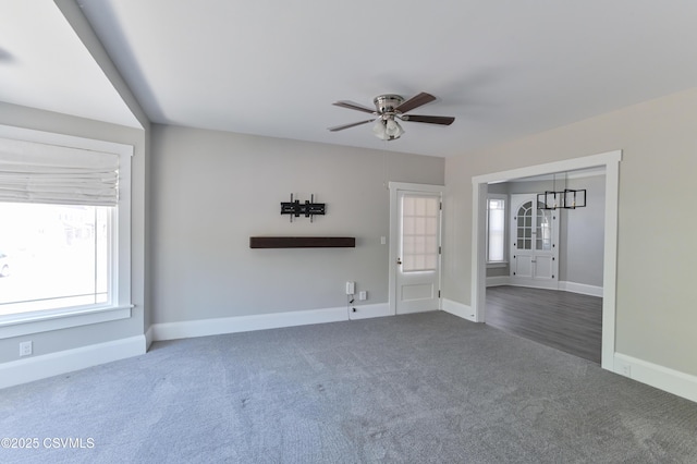 spare room with baseboards, a ceiling fan, and carpet