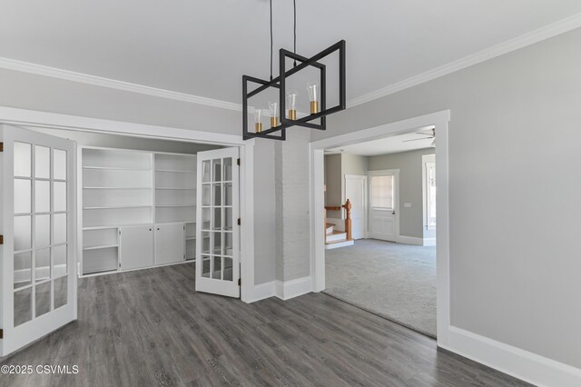 interior space with crown molding, baseboards, dark wood finished floors, and french doors