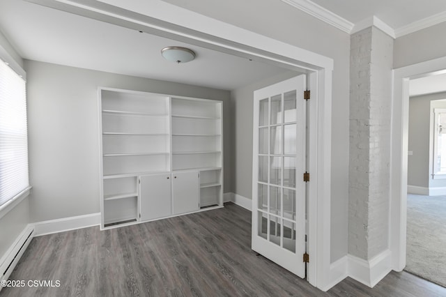 empty room with crown molding, a baseboard radiator, baseboards, and a healthy amount of sunlight