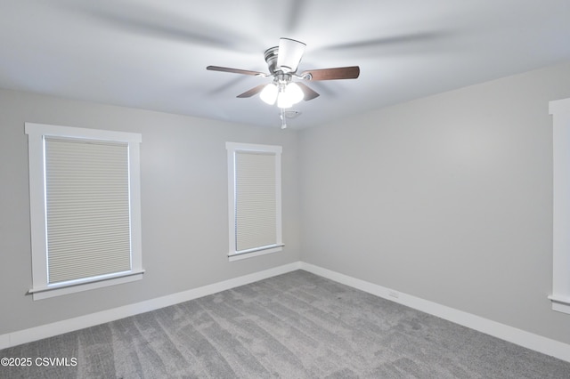 unfurnished room with ceiling fan, baseboards, and carpet