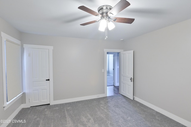 unfurnished bedroom featuring carpet flooring, a ceiling fan, and baseboards