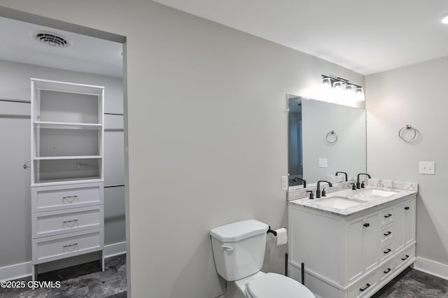 full bath with toilet, baseboards, visible vents, and a sink