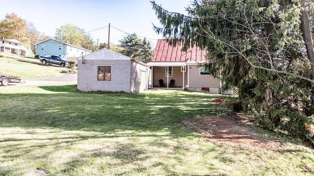 exterior space with a yard and metal roof