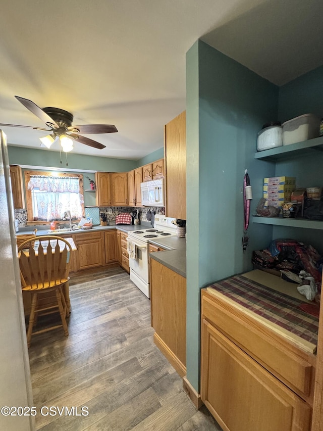 kitchen with white appliances, ceiling fan, a sink, light wood-style flooring, and backsplash
